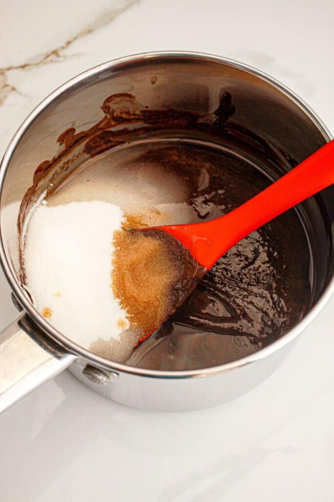 Sugar being added to a saucepan.