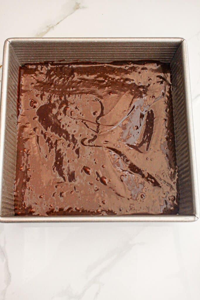 Batter in a square baking dish ready for the oven.