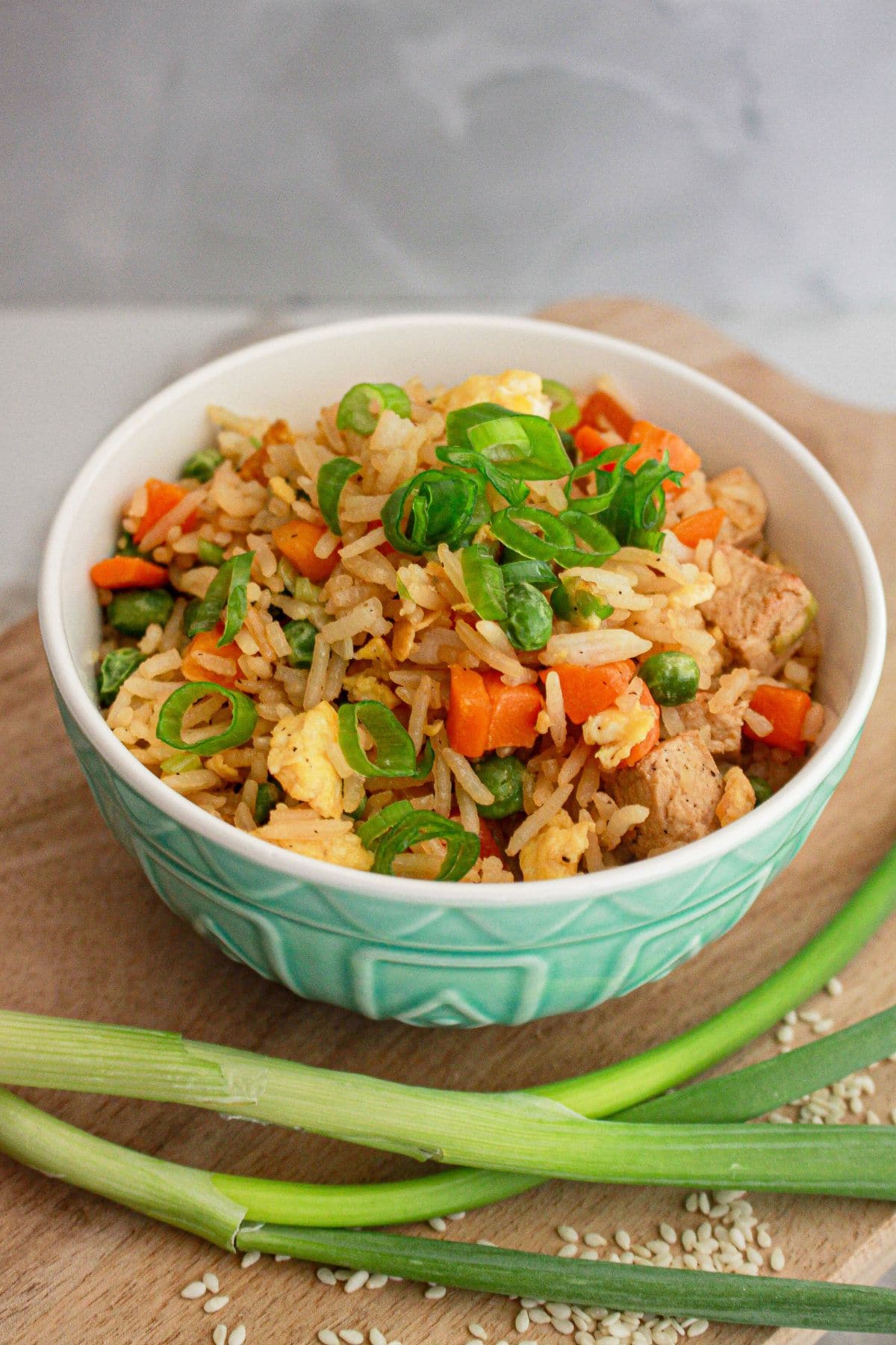 Bowl full of chicken fried rice on a counter.