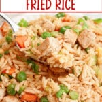 Bowl full of chicken fried rice on a counter.
