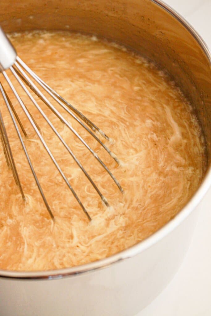 Eggs being added to soup.