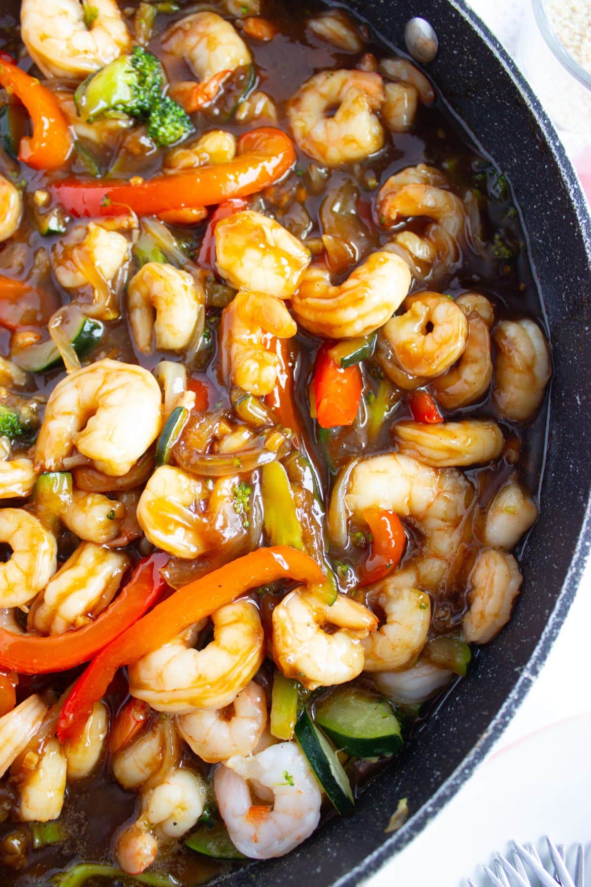 Skillet full of honey garlic shrimp stir fry.