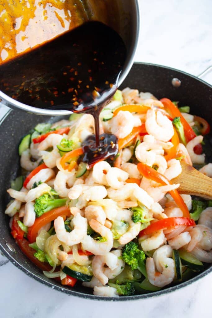 Sauce being added to skillet.