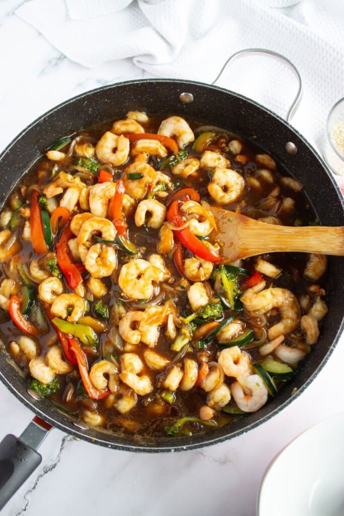 Skillet full of honey garlic shrimp stir fry.
