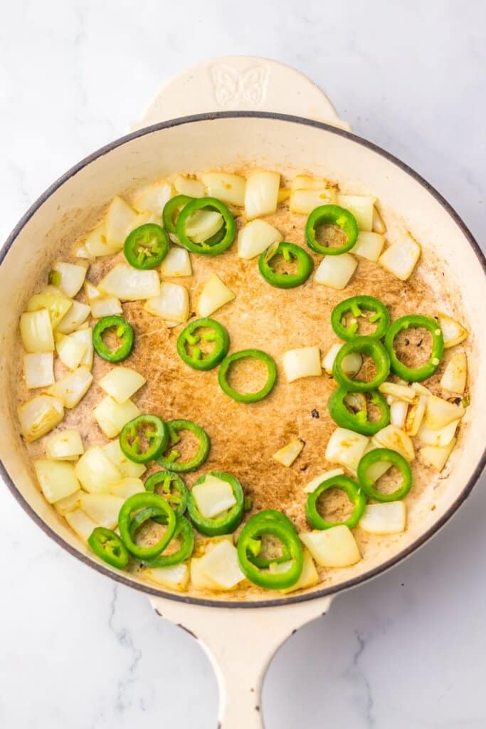 Peppers and onions in a skillet.