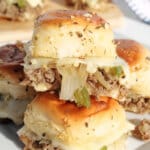 Philly cheesesteak sliders on a plate.