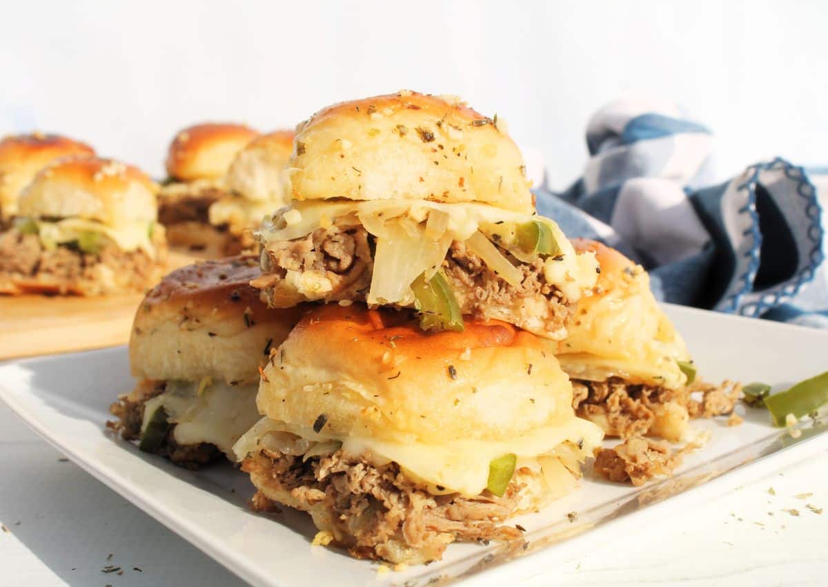 Philly cheesesteak sliders on a plate.
