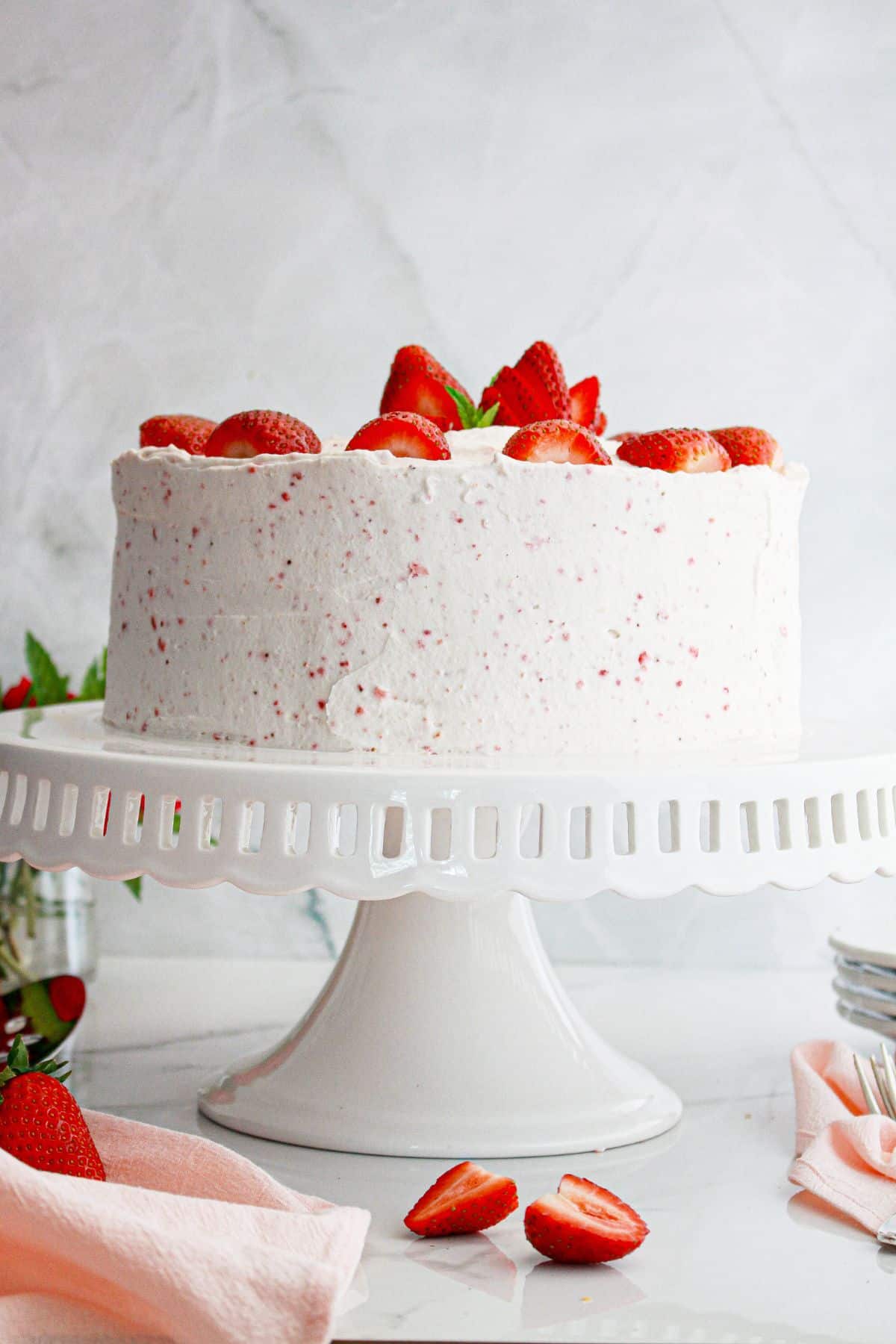 Strawberry Champagne Cake on a cake stand.