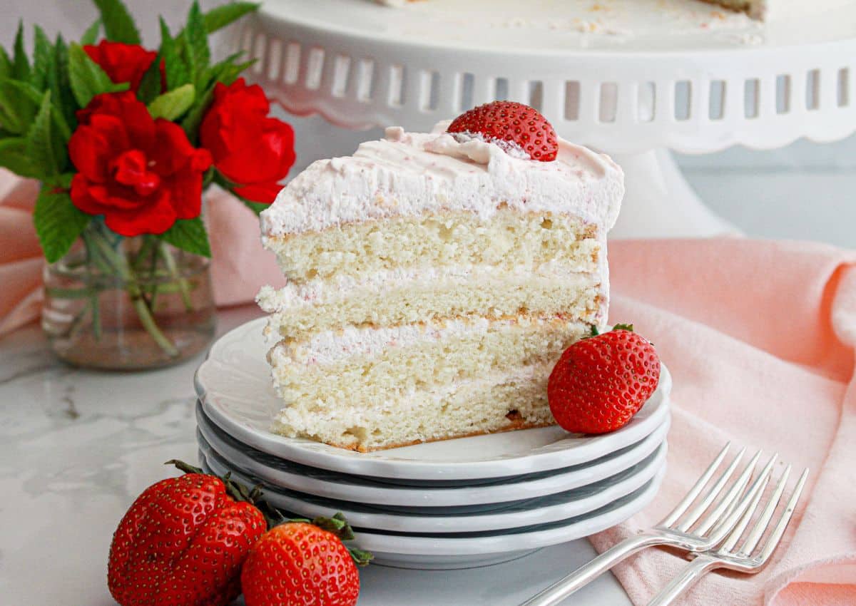 Slice of strawberry champagne cake on a plate.
