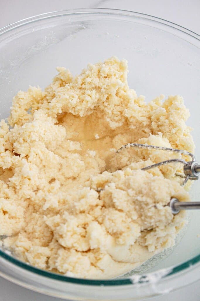Batter being mixed in a glass bowl.
