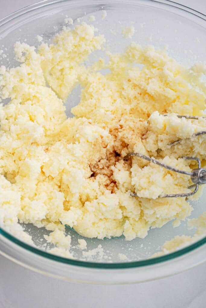 Butter, sugar, and vanilla being mixed together.