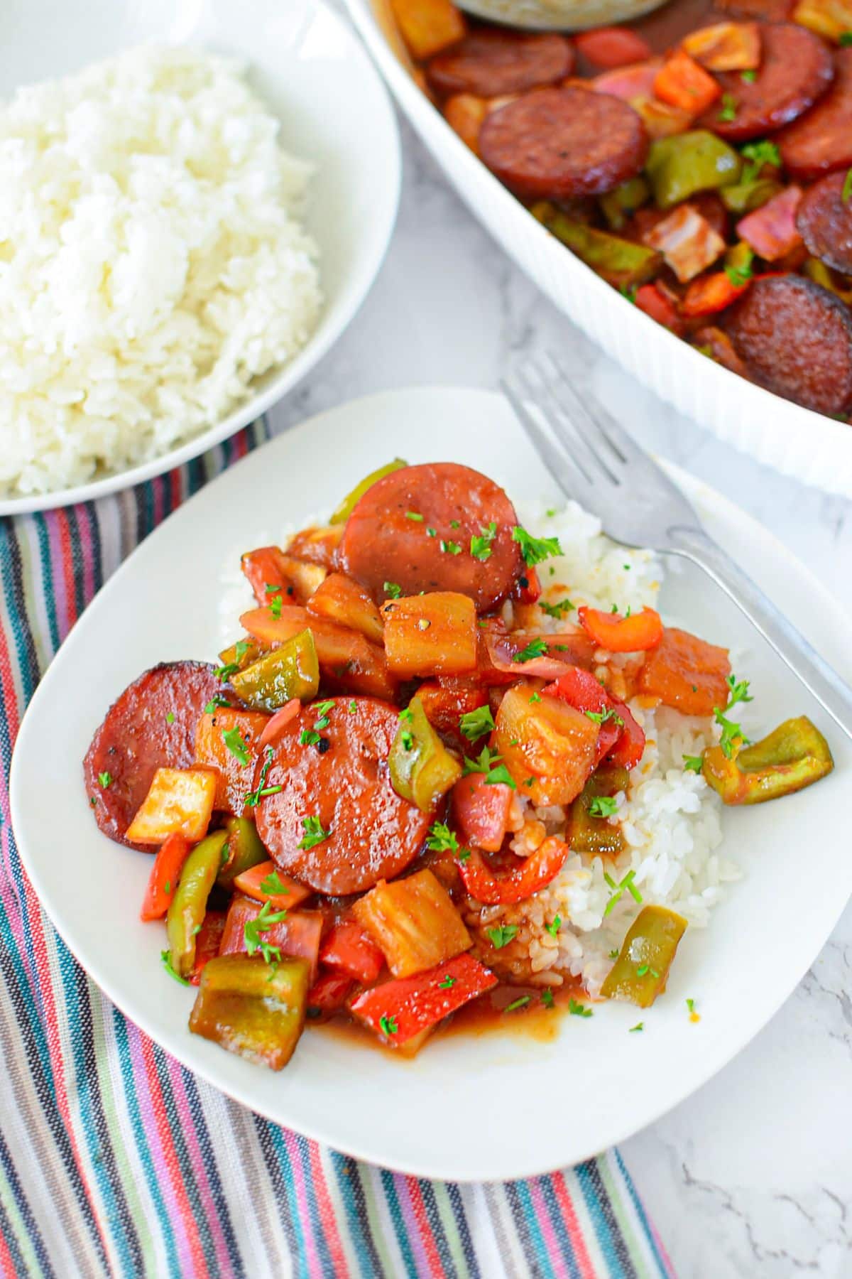 Plate full of sweet and sour kielbasa ready to serve.