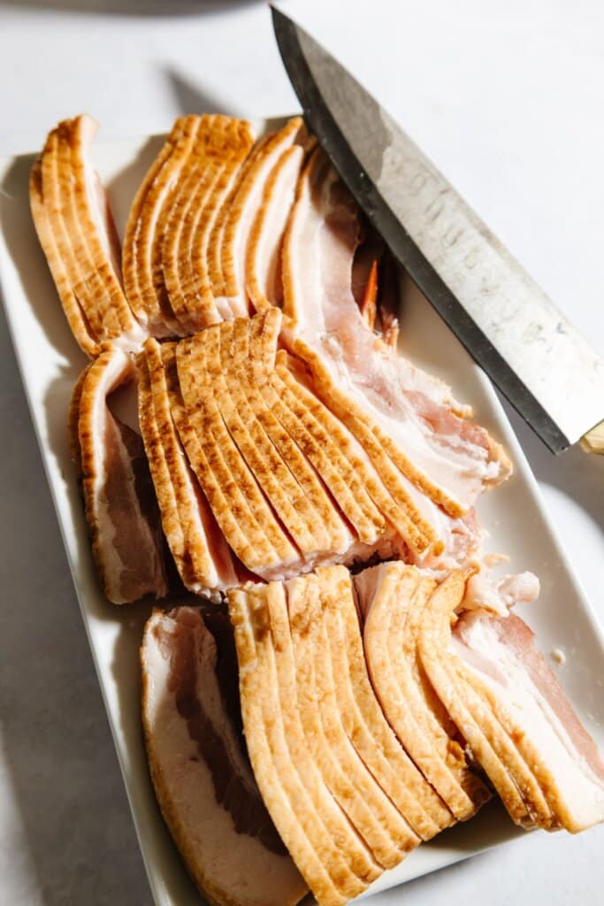 Bacon being cut into thirds.
