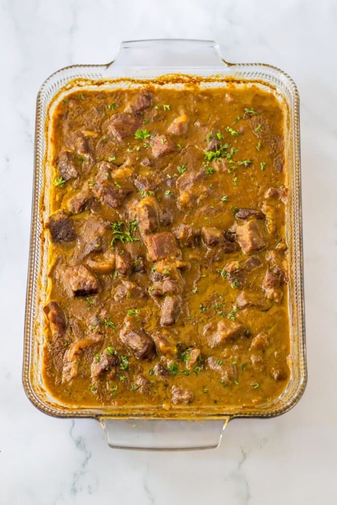 Glass baking dish full of beef tips and gravy.