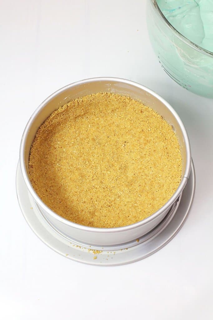 Graham cracker crust in a springform pan.