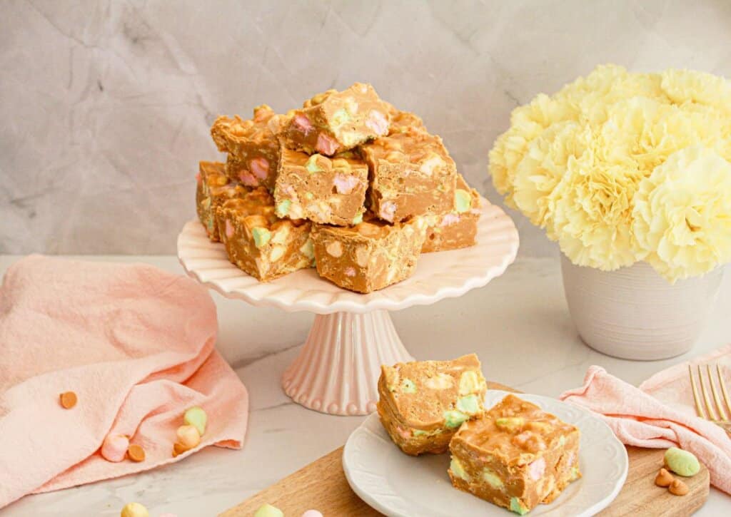 Butterscotch confetti squares on a cake plate.
