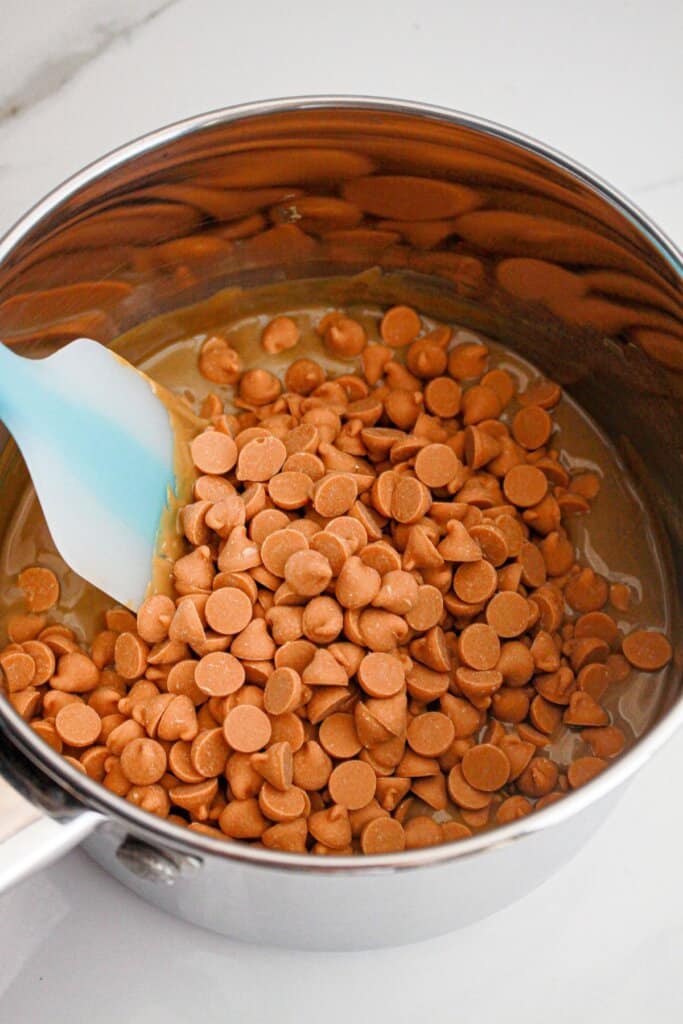 Butterscotch chips being melted in a saucepan.