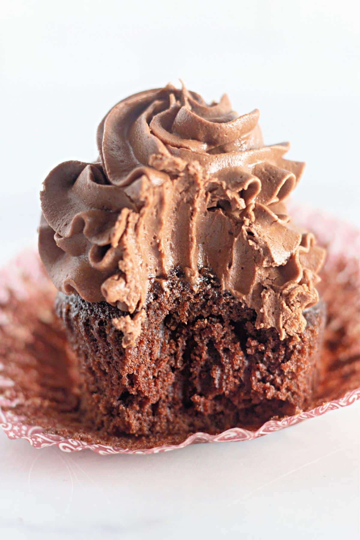 Chocolate cupcake with a bite missing.