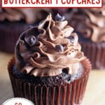 Chocolate buttercream cupcakes on a wooden cutting board.