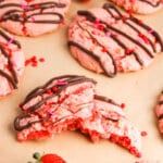 Choccolate covered strawberry cookies on a table.