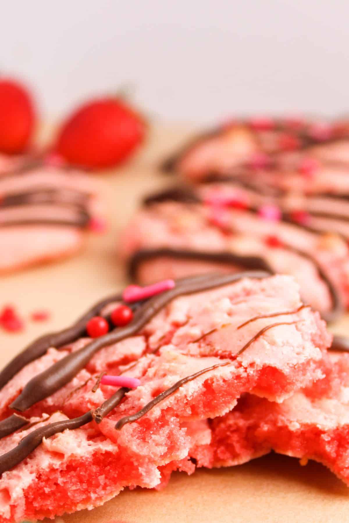 Choccolate covered strawberry cookies on a table.