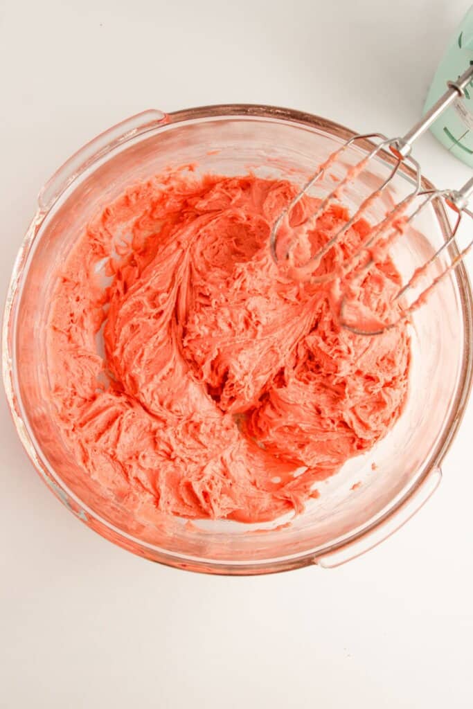 Dough being mixed in a glass bowl.