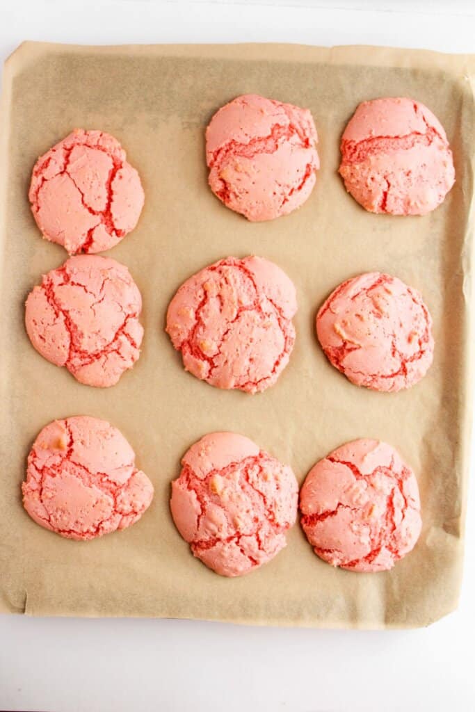 Baked cookies on a parchment lined baking sheet.
