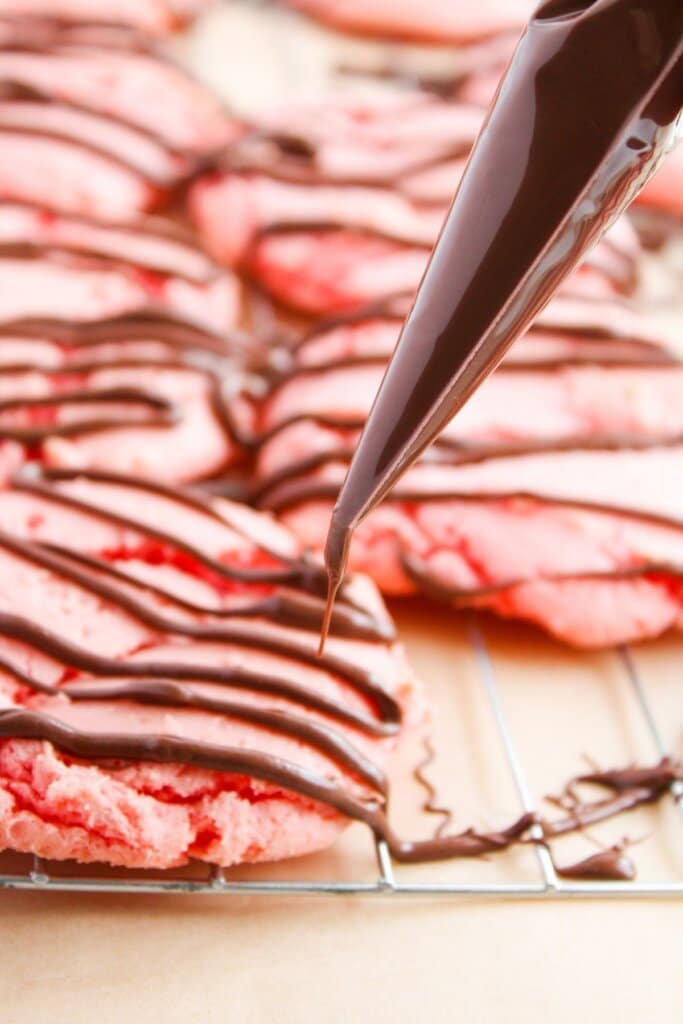 Melted chocolate being drizzled on a dessert.