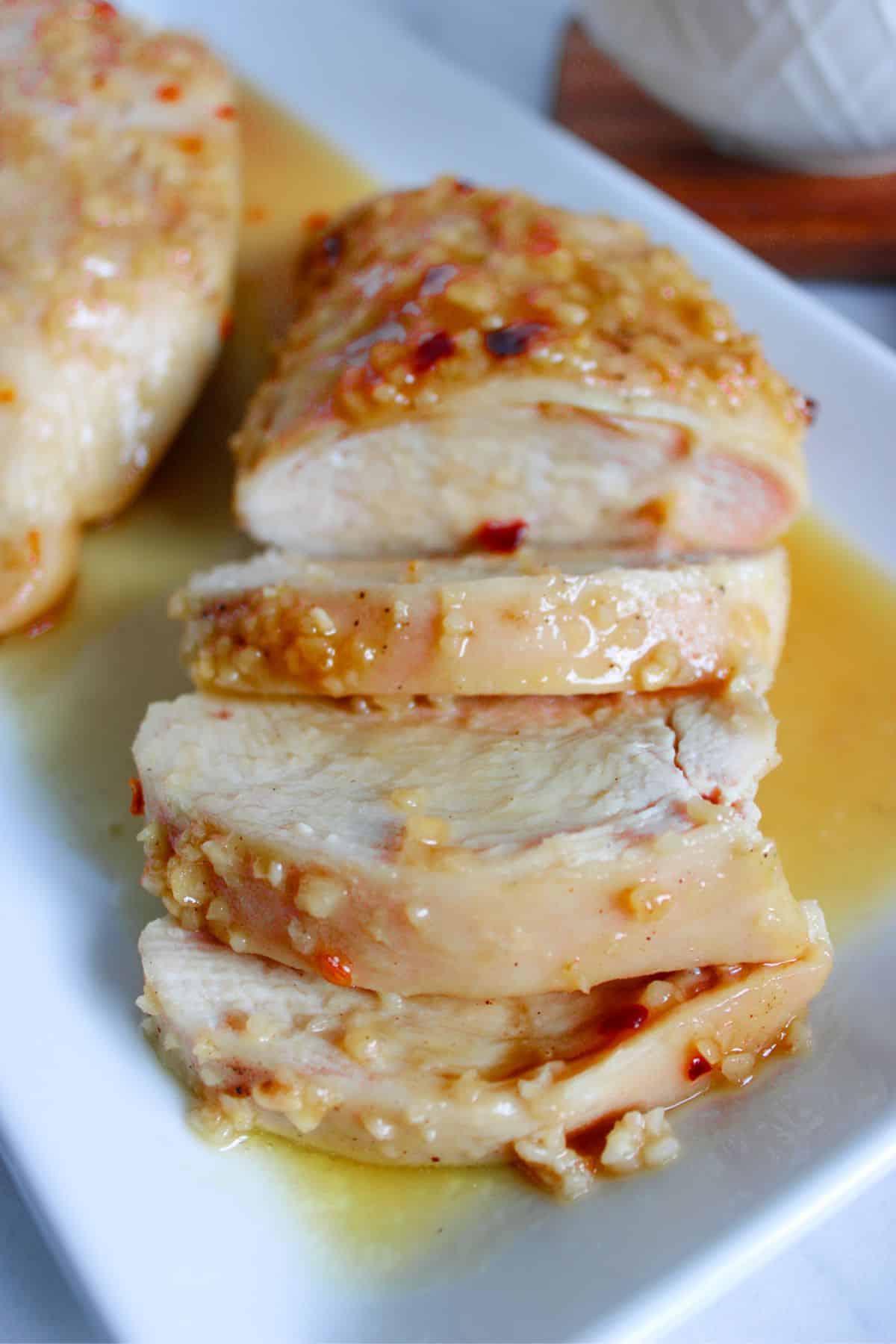 Honey garlic chicken breasts on a serving platter.