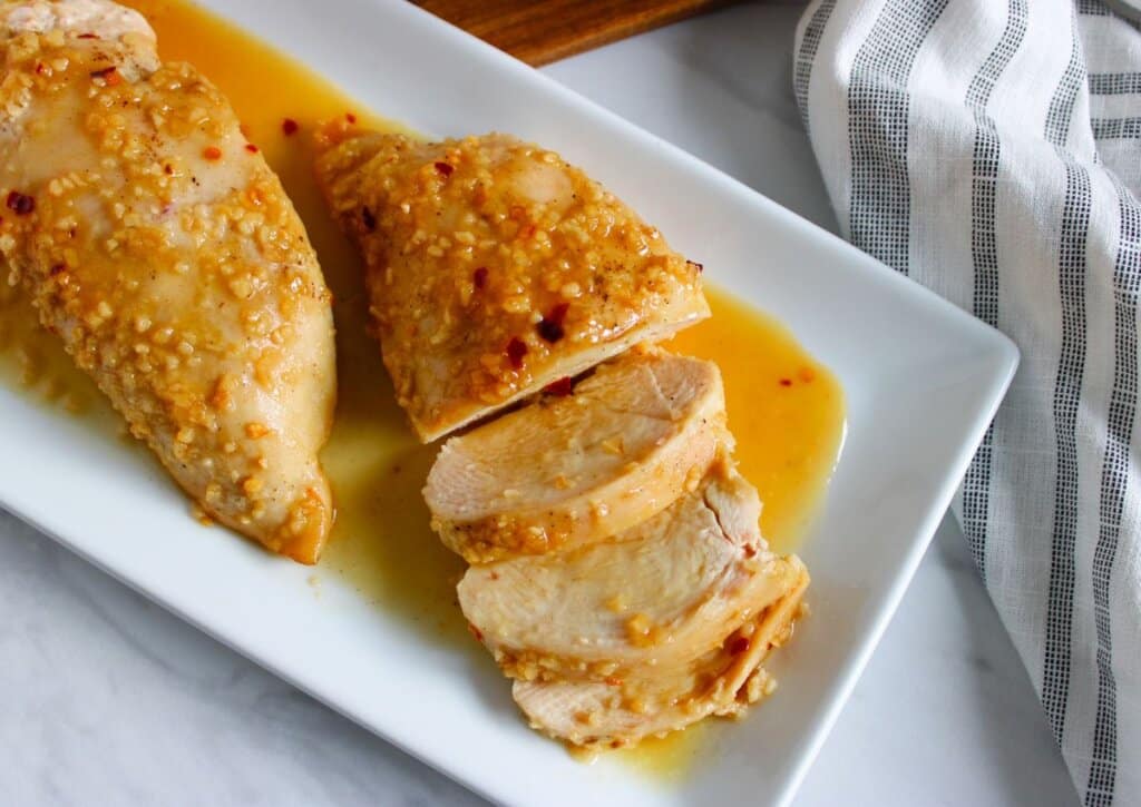 Honey garlic chicken breasts on a serving platter.