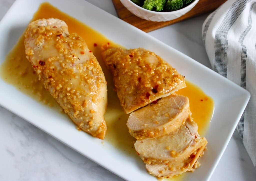 Honey garlic chicken breasts on a serving platter.
