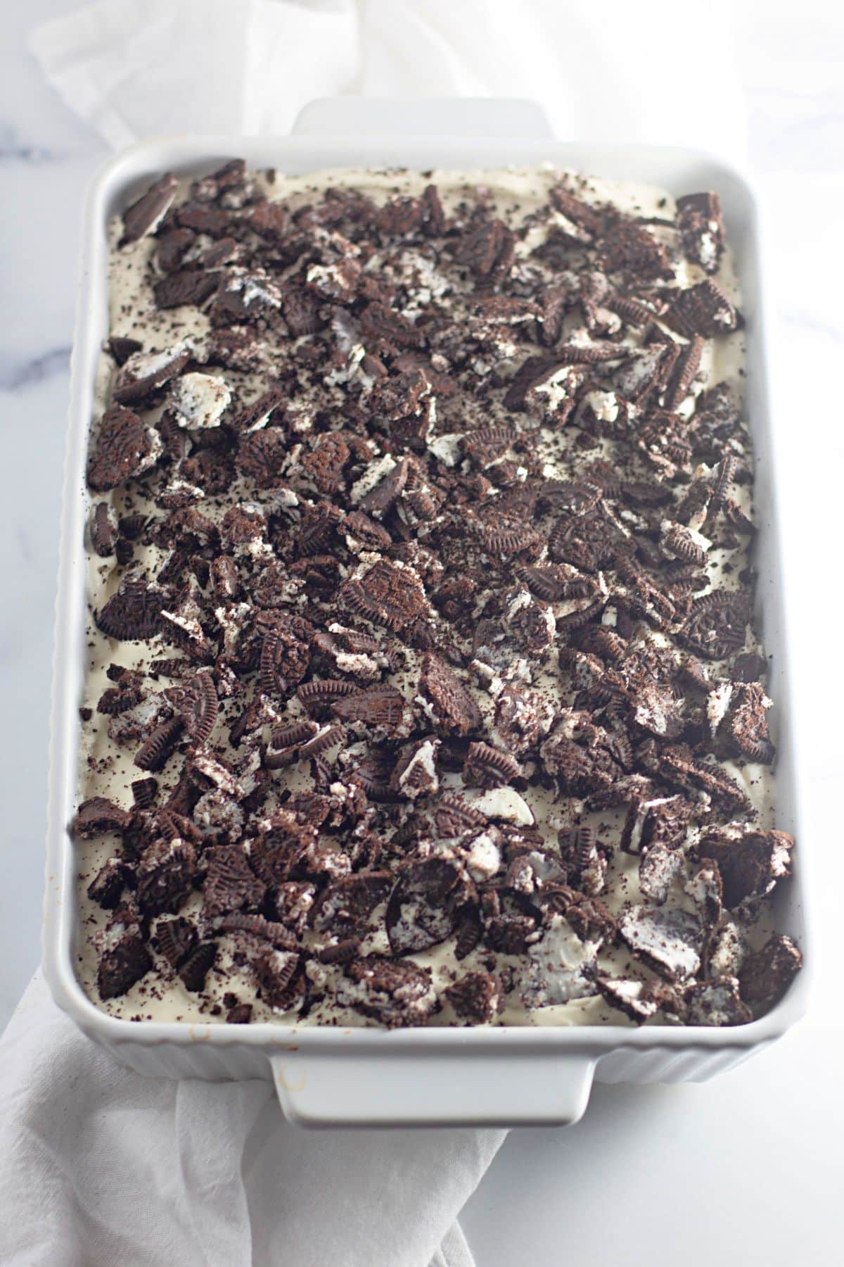Oreo poke cake in a baking dish.