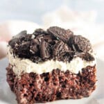 Oreo poke cake on a plate.