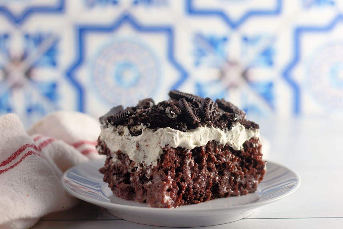 Slice of Oreo poke cake on a plate.