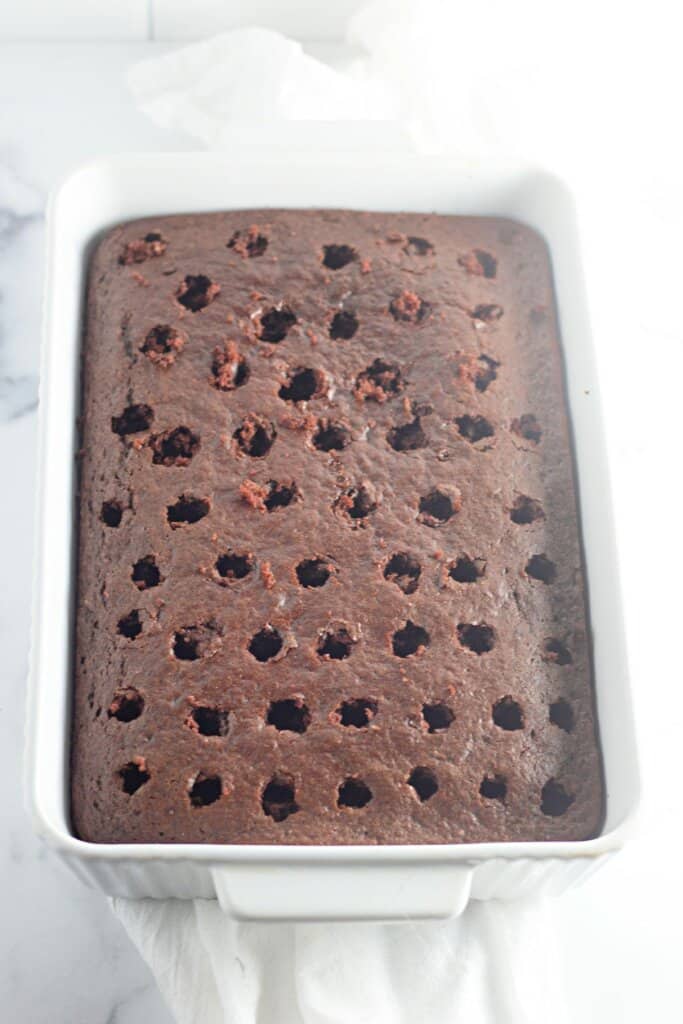 Holes being poked in a baking sheet.