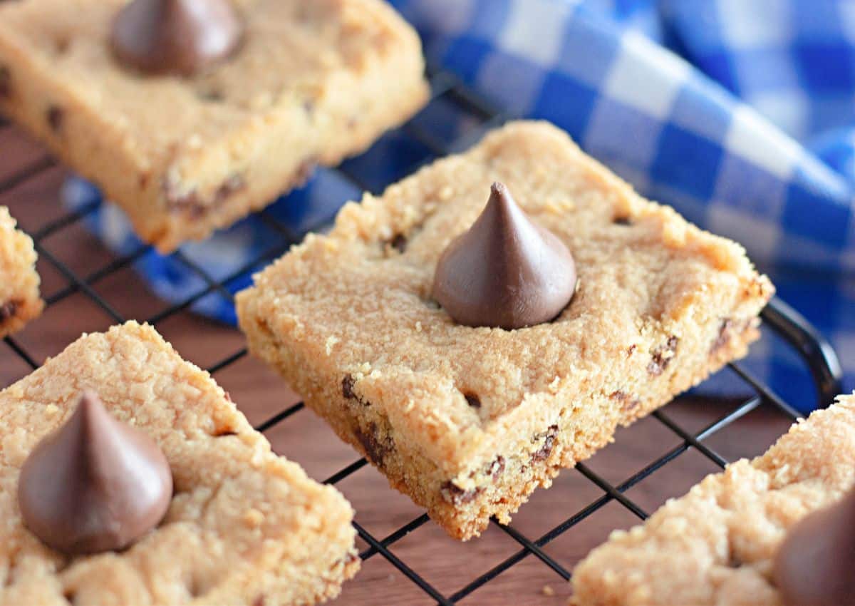 Baked peanut butter bars on a cooling rack.