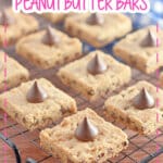 Baked peanut butter bars on a cooling rack.