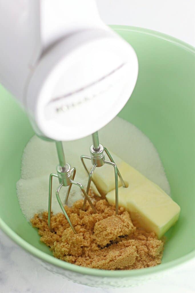 Butter, sugar, and brown sugar in a mixing bowl.