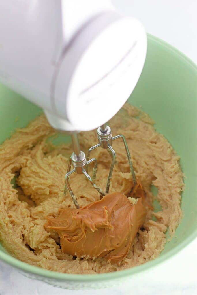 Peanut butter being added to batter.