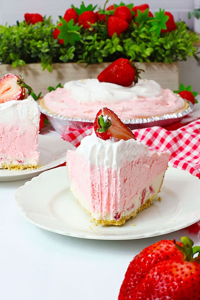 Slice of pink drink pie on a plate.