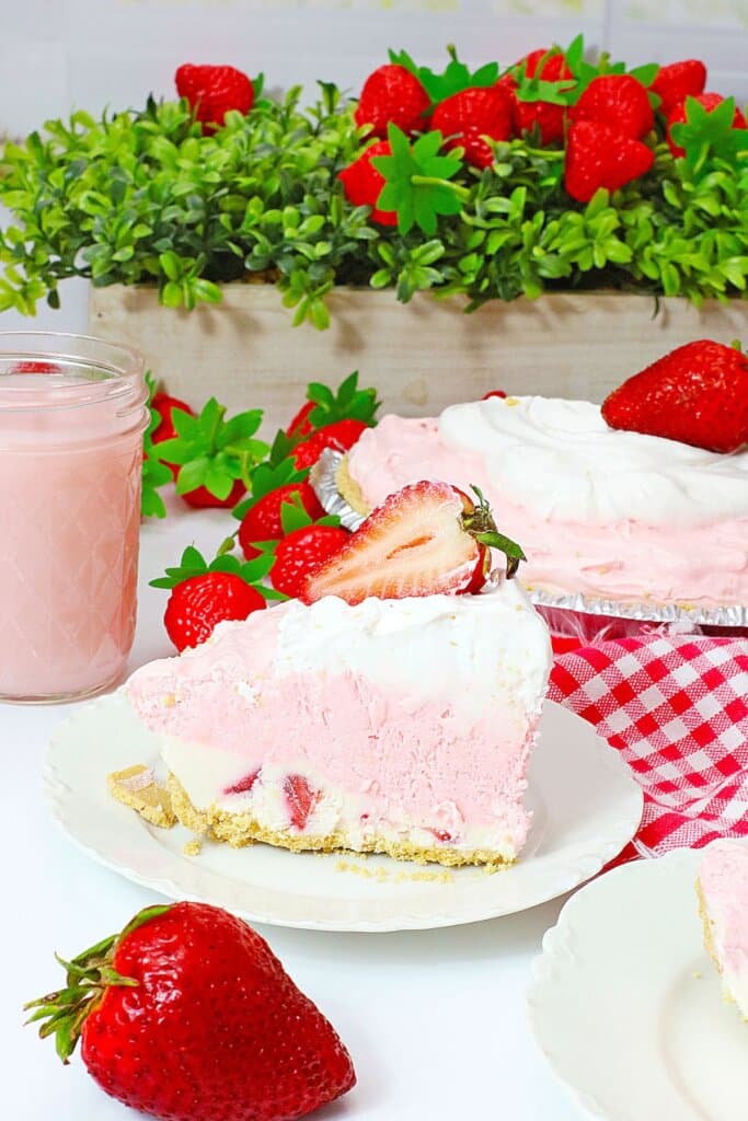 Slice of pink drink pie on a plate.