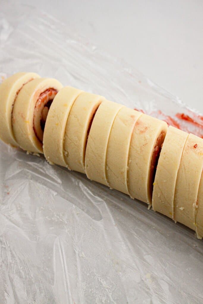 Dough being sliced into rounds.
