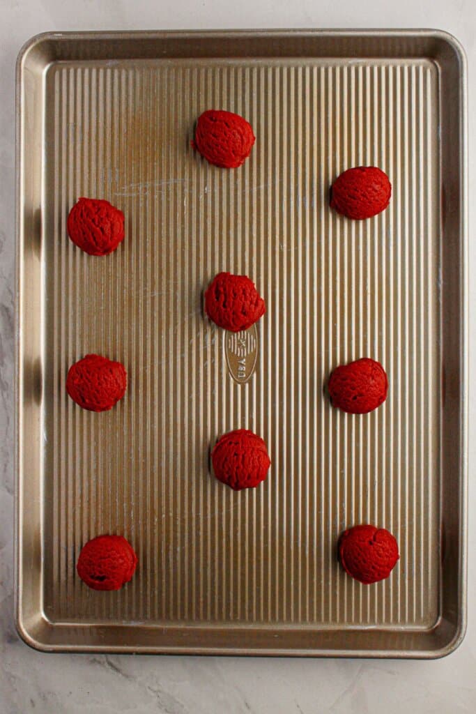 Cooke dough balls on a baking sheet on a baking sheet.