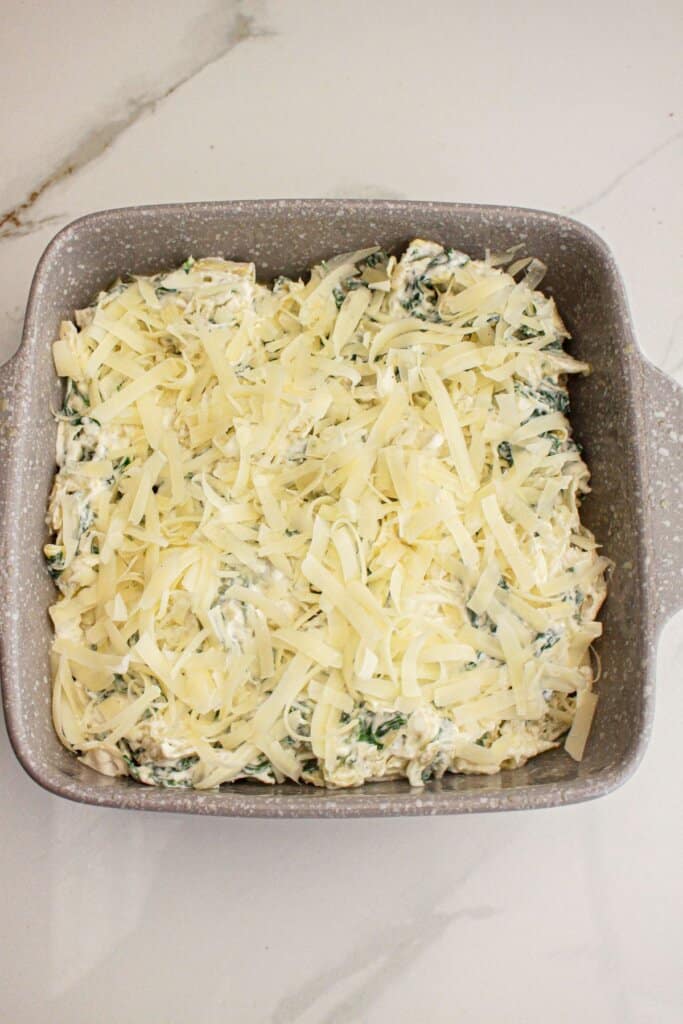Shredded cheese on top of a casserole dish.