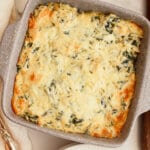 Casserole dish full of baked spinach dip.