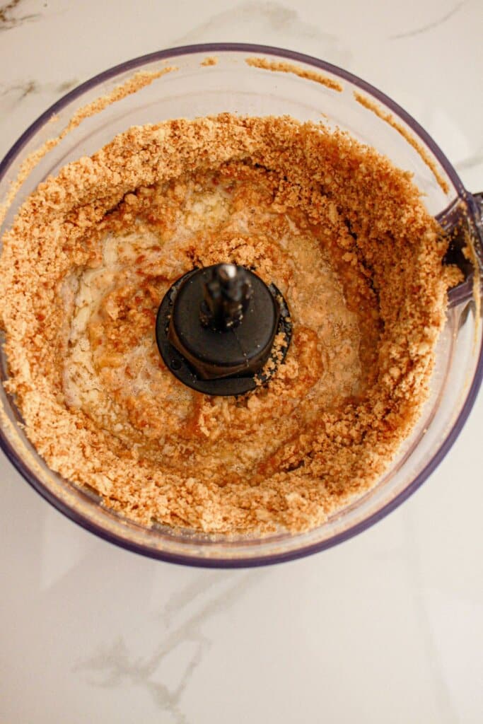 Oreo cookies and butter in a food processor.