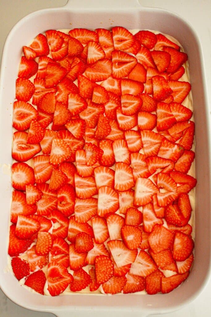 Strawberry slices on top of a dessert.