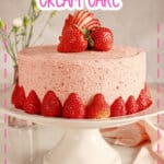 Strawberry cream cake on a cake stand.