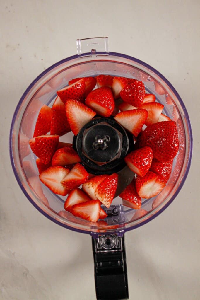 Strawberries in a food processor.