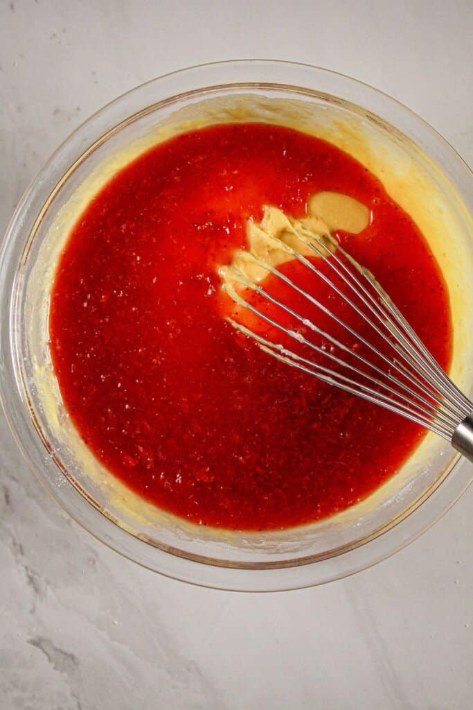Strawberry gelatin being added to batter.
